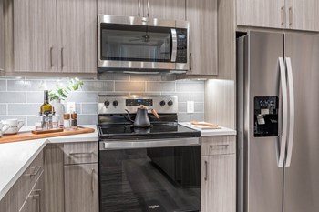 Kitchen with stainless steel appliances at Morea Apartments in Pompano Beach FL